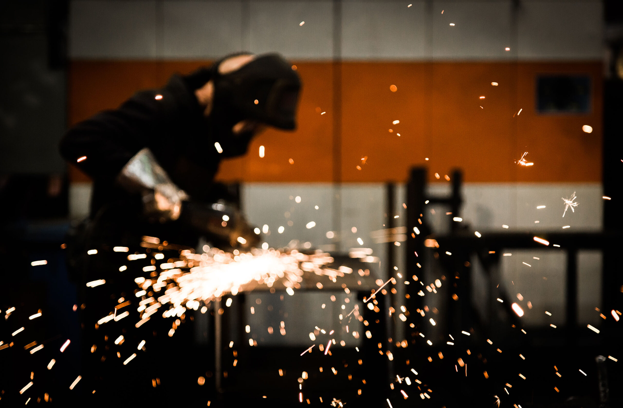 Welder welding with sparks flying 